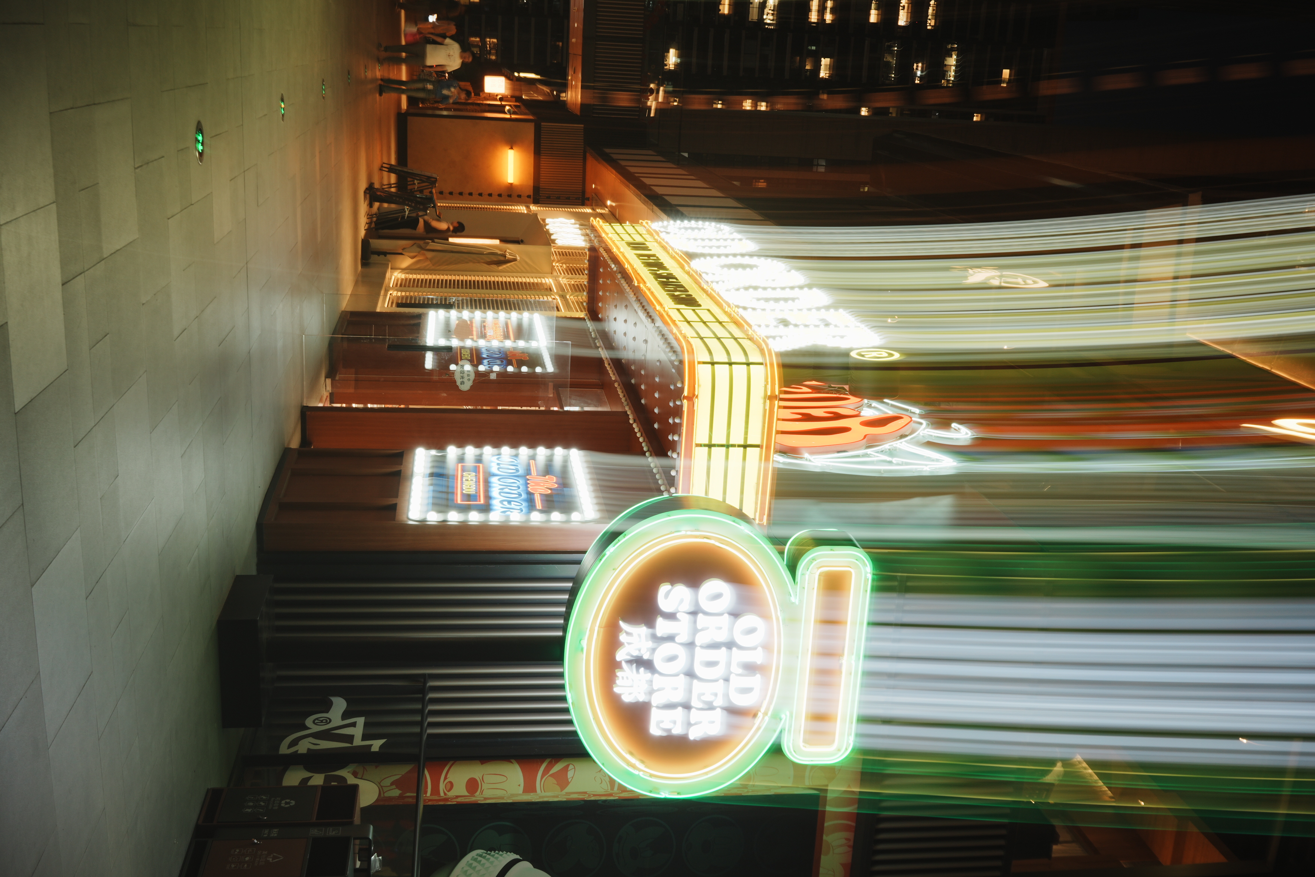 stylized neon store sign with streaks of shutter drag light