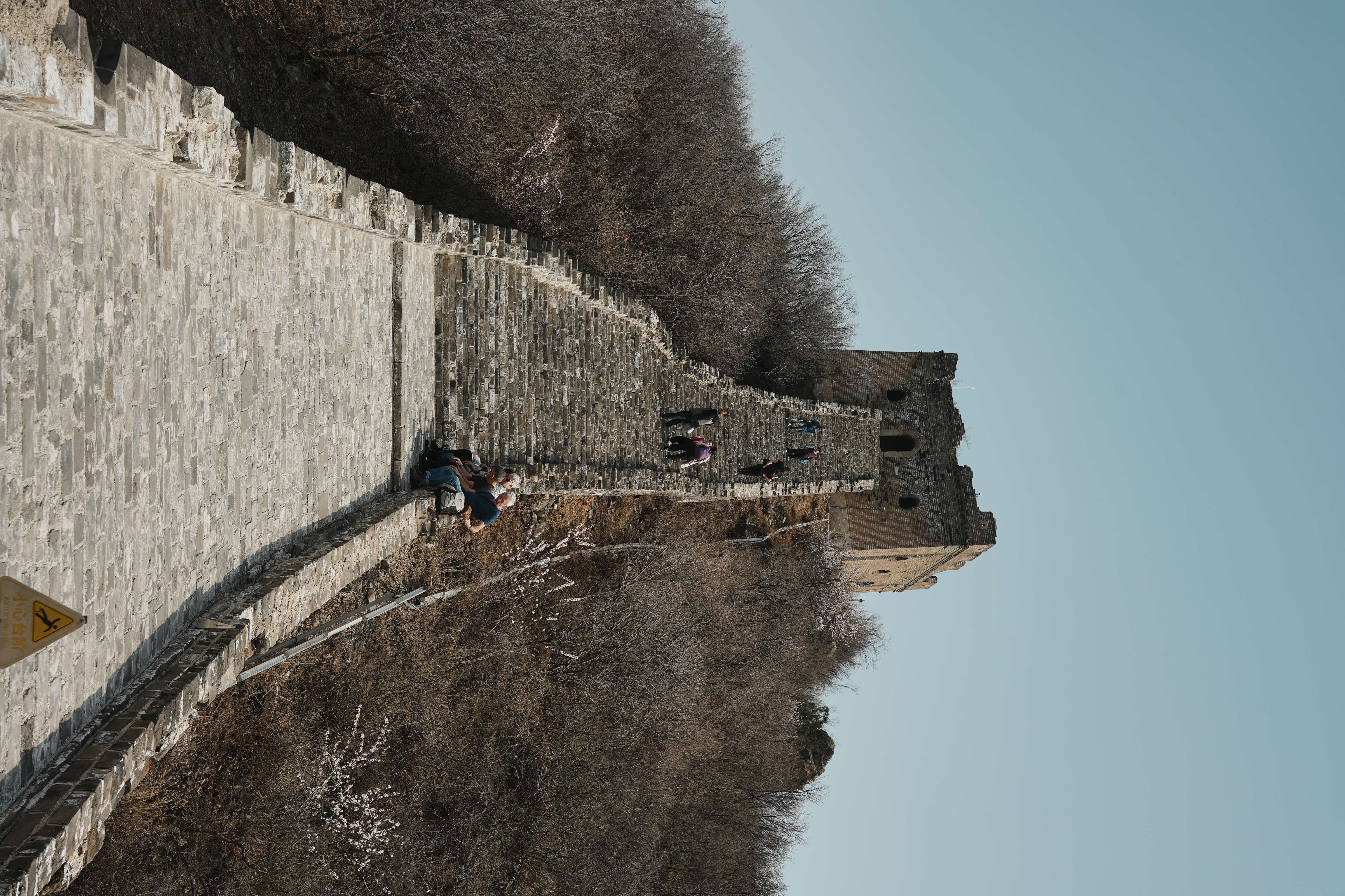 a rampart of the great wall connected to a straight and upwards path