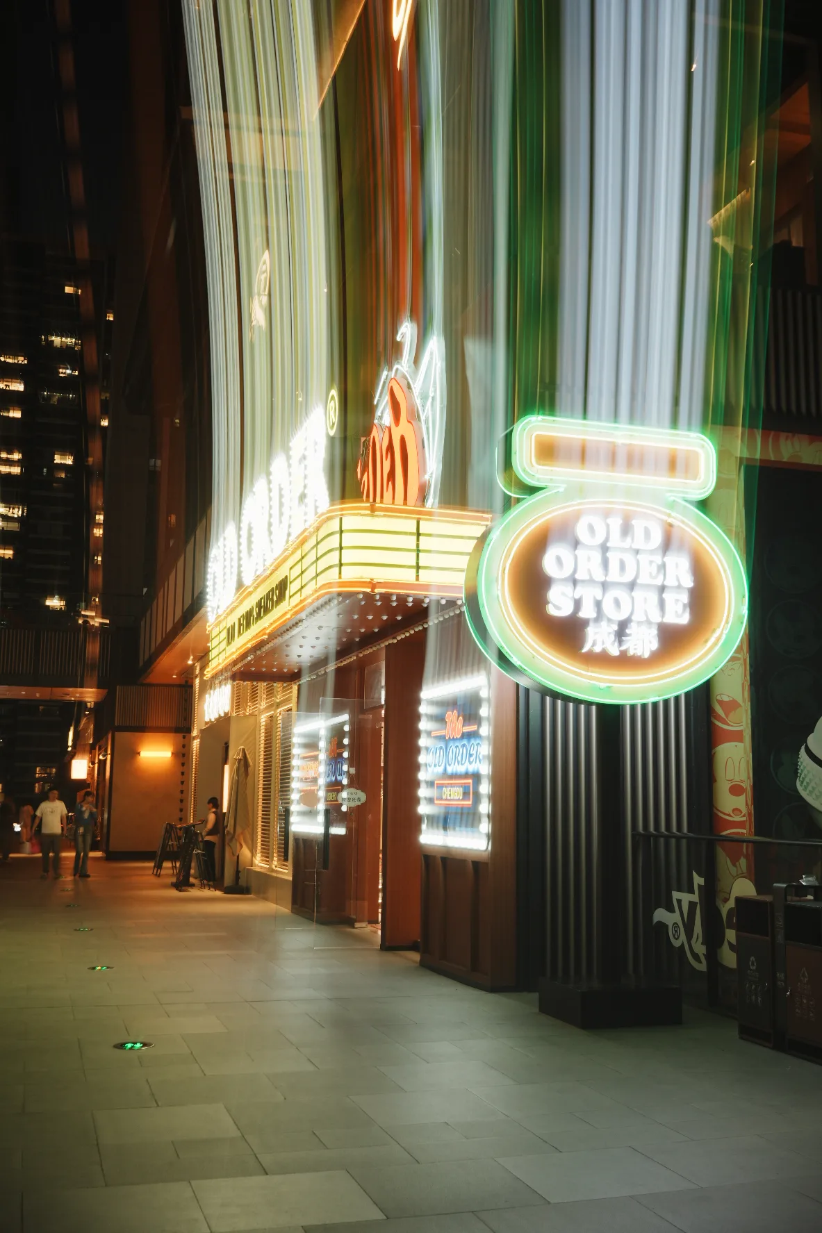 stylized neon store sign with streaks of shutter drag light