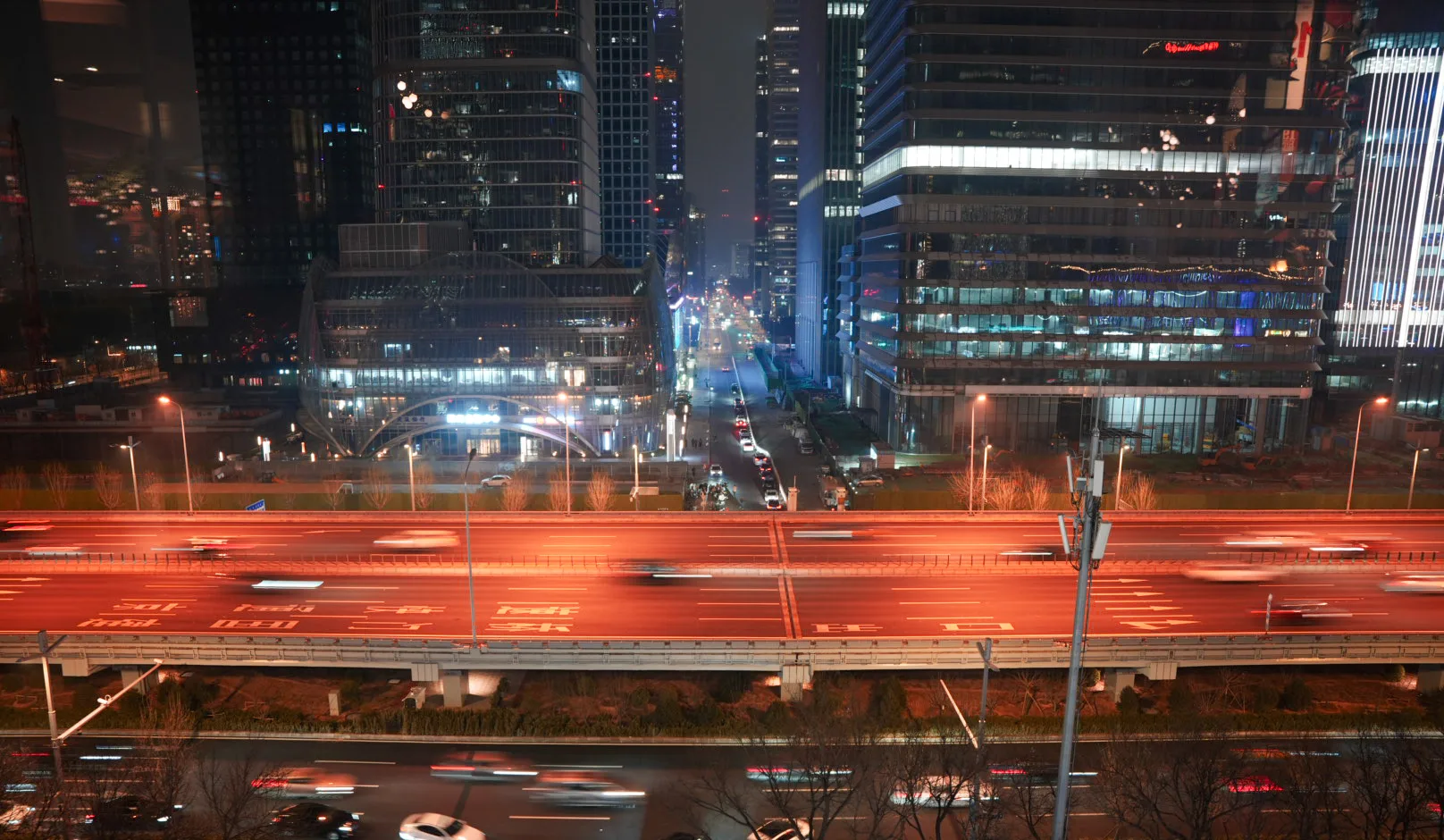 neon lit highway with streaks of cars